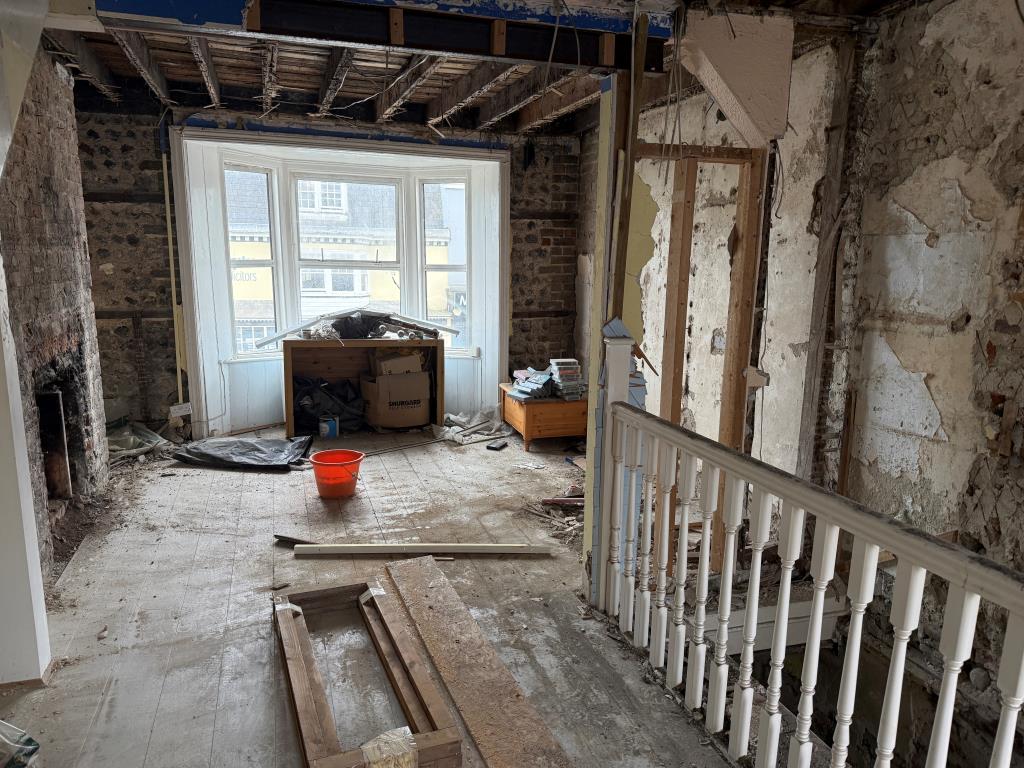 Lot: 52 - FREEHOLD SHOP AND UPPER PARTS IN NEED OF COMPLETE REFURBISHMENT - View of first floor room with window overlooking High Street